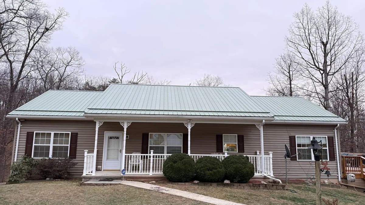Completed green metal roof installed by Strongbuilds LLC